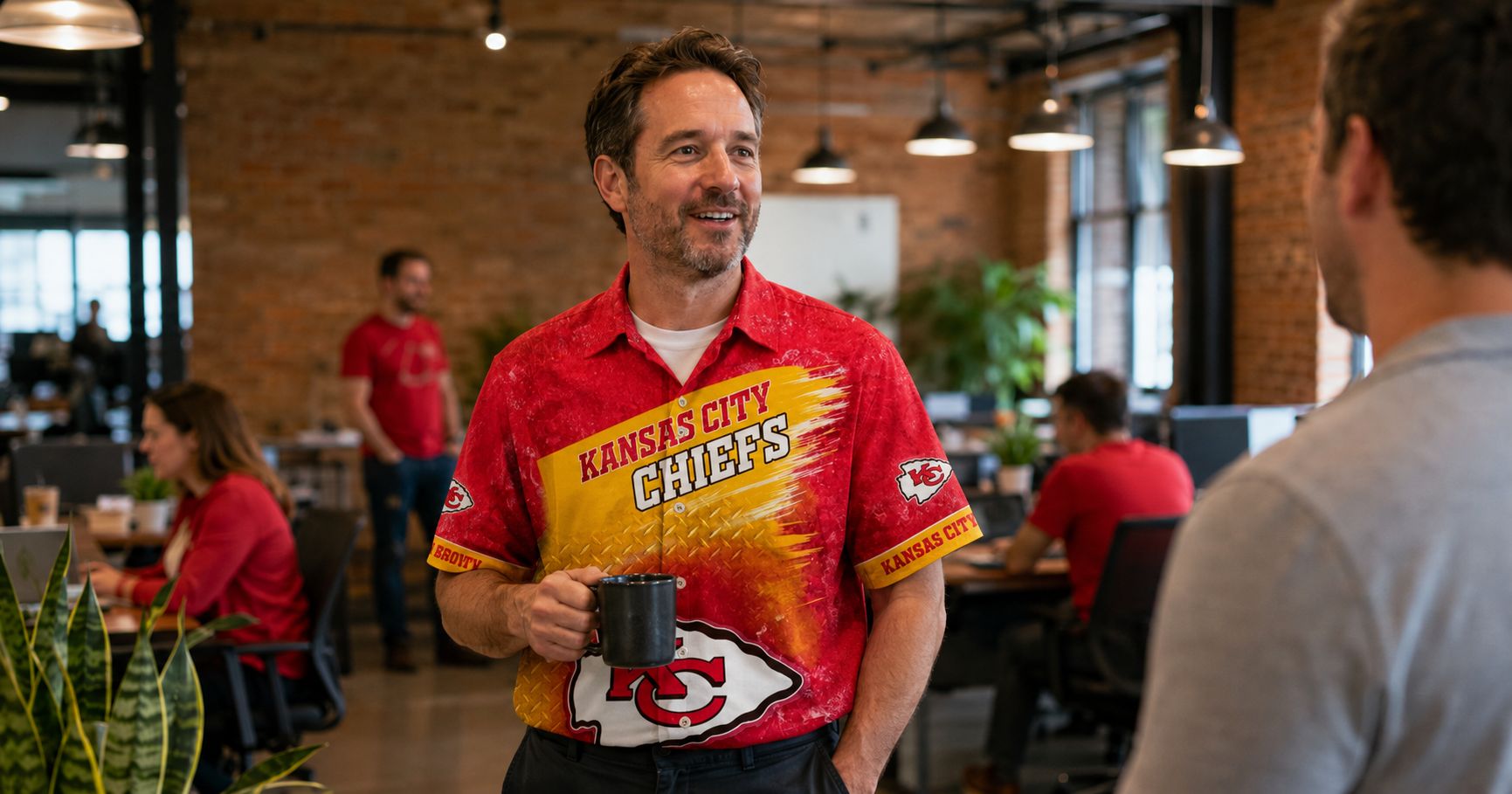 Kansas City Chiefs Hawaiian shirt worn at Kansas City office on Red Friday — fan wearing Chiefs gear among colleagues