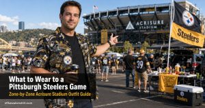 What to wear to a Pittsburgh Steelers game — man in Steelers Hawaiian shirt at North Shore tailgate with Acrisure Stadium behind him